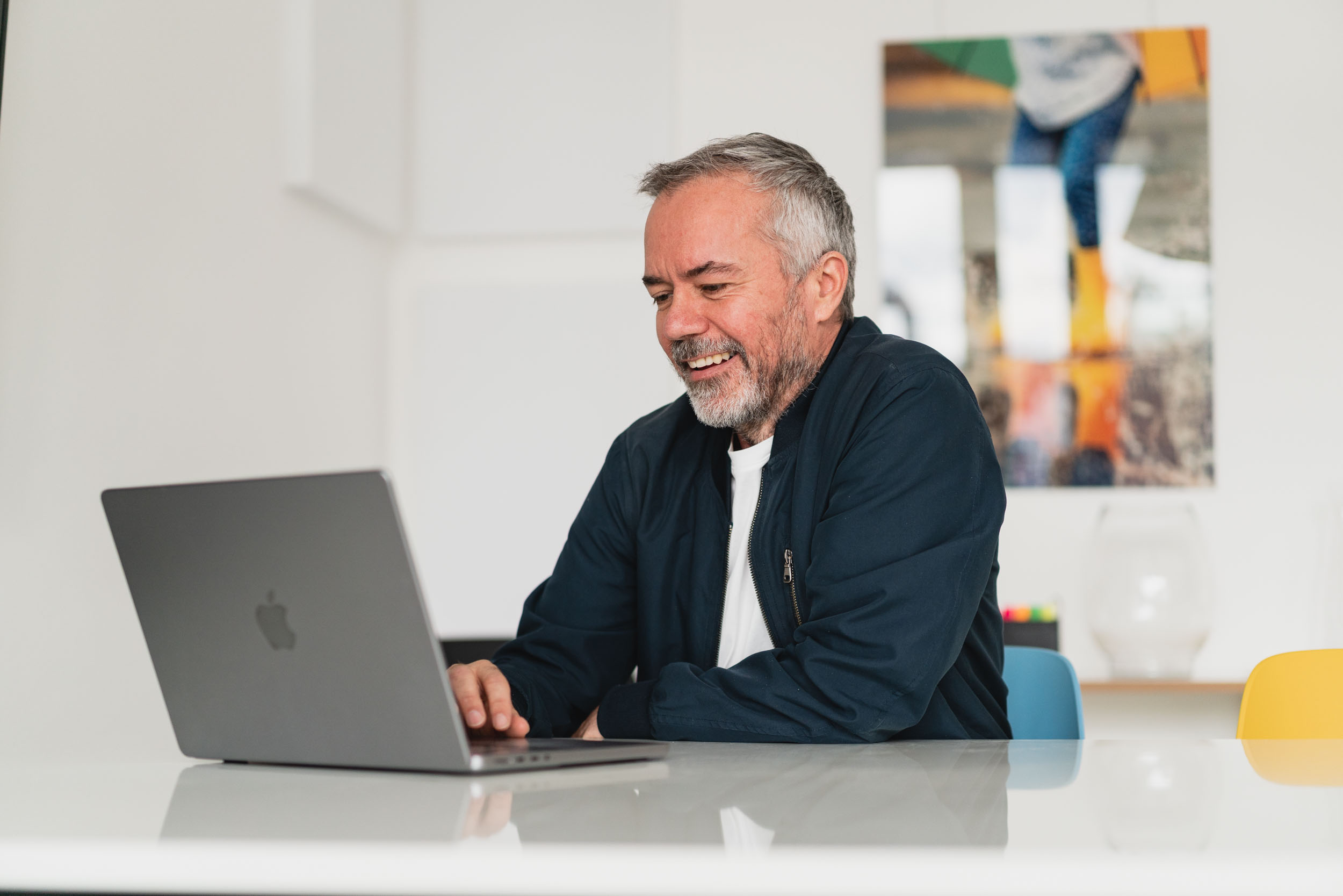 Referent György Csali sitzt am Laptop und lächelt